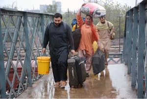 A couple arrives at the railway station with their luggage to leave for their hometown and celebrate Eid-ul-Fitr with their loved ones