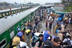 A couple arrives at the railway station with their luggage to leave for their hometown and celebrate Eid-ul-Fitr with their loved ones
