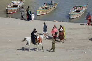 Children enjoying horse riding at AL-Manzar picnic point Indus river Jamshoro.