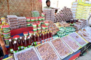 A vendor displaying Dates to attract the customers during Holy Fasting Month of Ramzan at Miro Khan Road