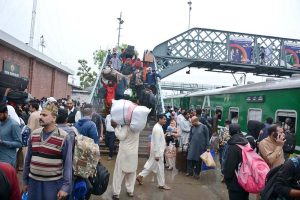 A large number of people arrives at the railway station to leave for their home town to celebrate Eidul Fitr with their loved ones