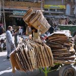 Labourers are busy loading cardboard onto the handcart at Raja Bazaar