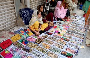 A vendor displaying Dates to attract the customers during Holy Fasting Month of Ramzan at Miro Khan Road