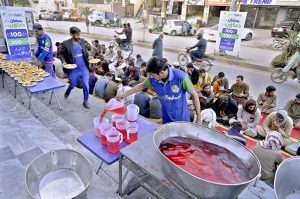 Volunteers prepare iftar meals for fasting people ahead of sunset during the holy month of Ramazan at National Market in the twin cities. APP/IFD/TZD/SSH
