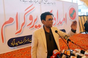 Federal Minister for Education and Professional Training Khalid Maqbool Siddiqui addressing during the distribution of relief goods at the Khidmat-e-Khalq Foundation