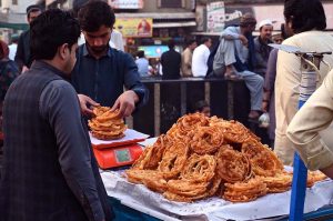 Vendor busy in preparing traditional food item Chapli kabab for the customers at Fawara Chowk.