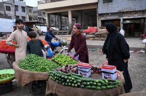 Labourers off-loading sacks of sugar bags from delivery truck at Vegetable Market