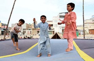 Children enjoy swings at Sadeqi Colony.