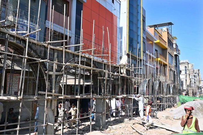 Labourers are busy in construction work of Model Bazaar at Raja Bazaar