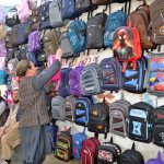 Vendor displaying school bags to attract the customers at his setup