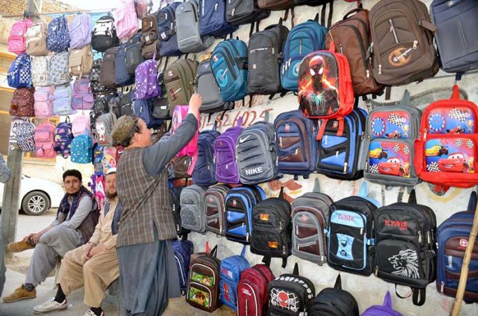 Vendor displaying school bags to attract the customers at his setup