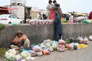 Labourers off-loading sacks of sugar bags from delivery truck at Vegetable Market