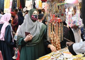 Women busy purchasing artificial jewelry during shopping in preparation for the upcoming Eid-ul-Fitr.