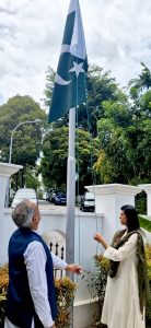 High Commissioner Rabia Shafiq hoisting the national flag at Pakistan House, to the tune of the National Anthem, marking the commemoration of the 86th National Day of Pakistan
