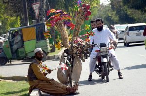 Hard work and long wait is the key to success. A street hawker displays paper toys to attract the customers along the roadside. APP/AHF/ABB