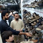 People select footwear as Eid preparations continue in the city.
