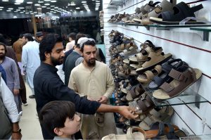 People select footwear as Eid preparations continue in the city.