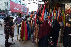 An elderly tailor stitching clothes at his shop ahead of the upcoming Eid-ul-Fitr