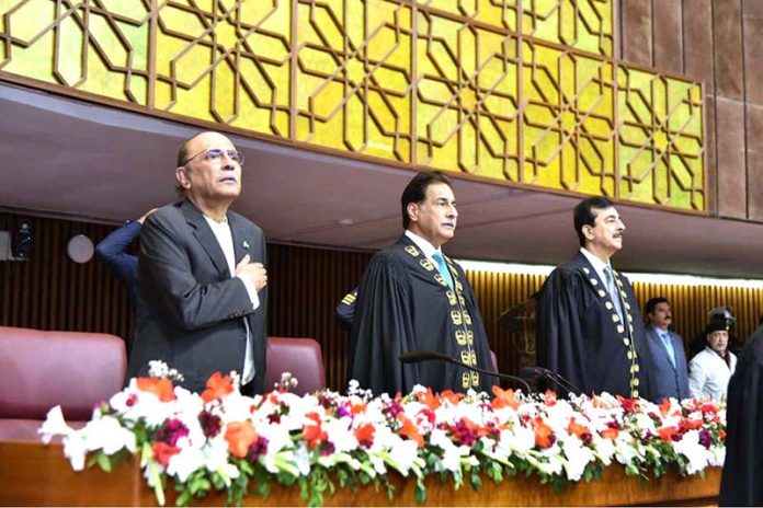 President Asif Ali Zardari, Speaker National Assembly Sardar Ayaz Sadiq and Chairman Senate Syed Yousuf Raza Gilani stand for the National Anthem at the joint session of Parliament at Parliament House