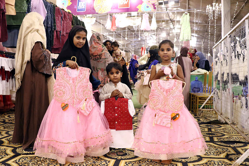 Children expressing joy while selecting Eid dresses of their choice at a free Eid bazaar titled “Maa Hum Bhi Eid Manayenge,” organized by JDC Welfare Foundation for deserving people
