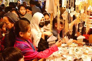 A large number of people are busy shopping in preparation of Eidul Fitr at Resham Bazaar