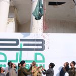 Commissioner Amir Kareem Khan and RPO Muhammad Usman Akram Gondal hoisting the National flag to mark the Pakistan Day ceremony at the DC office
