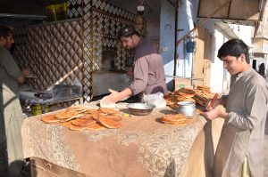 A naanbai prepares traditional kulchas for Sehri during Ramazan, keeping alive the flavor of local culinary traditions.
