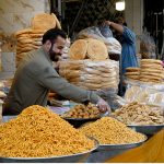 A vendor displays and sells freshly fried Nimko and Papri, attracting customers during the holy month of Ramazan