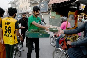 Customers purchase food items from a roadside stall to break their fast during Iftar in the holy month of Ramazan at G-9 market