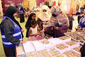 Children expressing joy while selecting Eid dresses of their choice at a free Eid bazaar titled “Maa Hum Bhi Eid Manayenge,” organized by JDC Welfare Foundation for deserving people