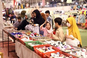 Children expressing joy while selecting Eid dresses of their choice at a free Eid bazaar titled “Maa Hum Bhi Eid Manayenge,” organized by JDC Welfare Foundation for deserving people