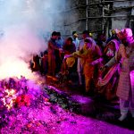 Hindu devotees offer prayers while celebrating Holi at Shree Punch Mukhi Hanuman Mandir.