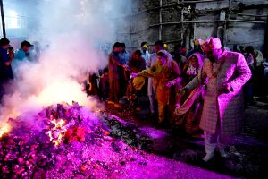 Hindu devotees offer prayers while celebrating Holi at Shree Punch Mukhi Hanuman Mandir.