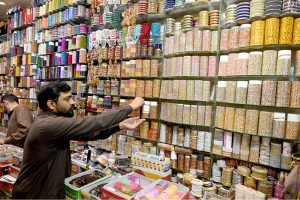 A vendor displays and sells freshly fried Nimko and Papri, attracting customers during the holy month of Ramazan