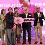 Sharjeel Inam Memon, Sindh Senior Minister and Provincial Minister for Information, Transport and Communication, along with others, hands over the key of a scooty to a woman during a ceremony for the distribution of scooties on the occasion of International Women’s Day at a local hotel