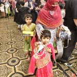 A mother along with her children is expressing joy by selecting Eid dresses of their choice on Chand Raat at the Eid Free Bazaar 'Maa Hum Bhi Eid Manyen Gay,' organized by the JDC Welfare Foundation
