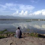 A mesmerizing view of Rawal Lake reflecting clouds on its calm waters