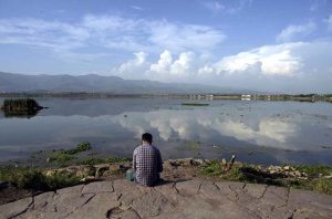 A mesmerizing view of Rawal Lake reflecting clouds on its calm waters