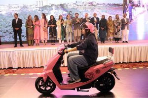 Sharjeel Inam Memon, Sindh Senior Minister and Provincial Minister for Information, Transport and Communication, along with others, hands over the key of a scooty to a woman during a ceremony for the distribution of scooties on the occasion of International Women’s Day at a local hotel