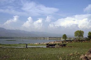 A mesmerizing view of Rawal Lake reflecting clouds on its calm waters