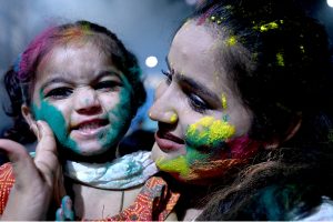 Hindu devotees offer prayers while celebrating Holi at Shree Punch Mukhi Hanuman Mandir.