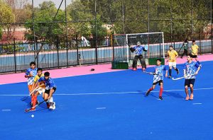 A view of the hockey match played between Crescent Young Hockey Club and ABG Junior Hockey Club during the Hockey Festival organized by Crescent Hockey Club and Fatima Women Hockey Academy at Austro Turf Hockey Stadium, as a rainbow appears in the sky after rainfall in the city.