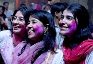 Hindu devotees offer prayers while celebrating Holi at Shree Punch Mukhi Hanuman Mandir.