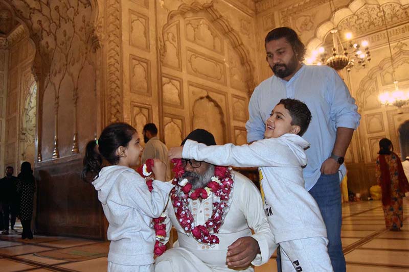 People receiving faithful who complete Itikaf at Badshahi Masjid on the last night of Ramazan