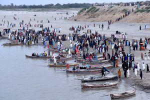 A large number of people enjoying Eid holidays with boat ridding at AL-Manzar point in River Indus