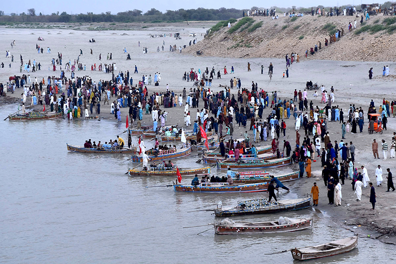 A large number of people enjoying Eid holidays with boat ridding at AL-Manzar point in River Indus