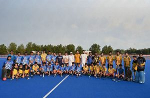 A view of the hockey match played between Crescent Young Hockey Club and ABG Junior Hockey Club during the Hockey Festival organized by Crescent Hockey Club and Fatima Women Hockey Academy at Austro Turf Hockey Stadium, as a rainbow appears in the sky after rainfall in the city.