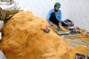 A worker packing vermicelli ahead of Eid ul Fitr festive at his workplace in the city