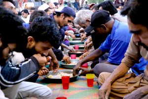 People break their fast during Free Iftar at the roadside in the city during the holy fasting month of Ramazan.