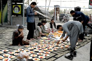Volunteers prepare and arrange food items during Free Iftar at the roadside in the I-9 sector during the holy fasting month of Ramazan.